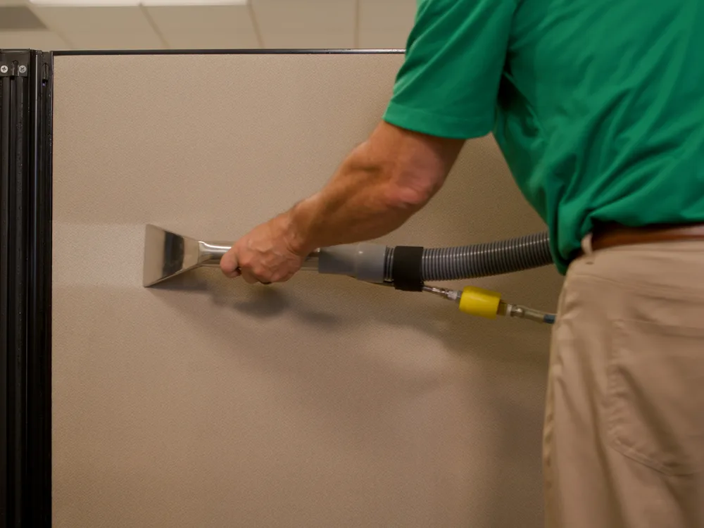 Chem-Dry technician cleaning an office cubicle workstation