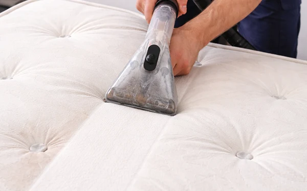 A Chem-Dry technician cleaning a mattress