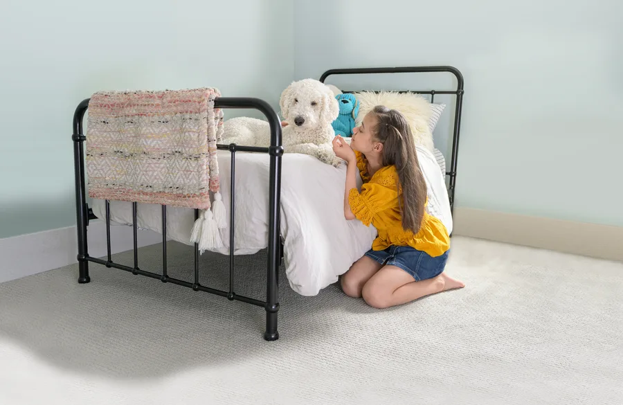 A girl and her dog relaxing on a clean mattress