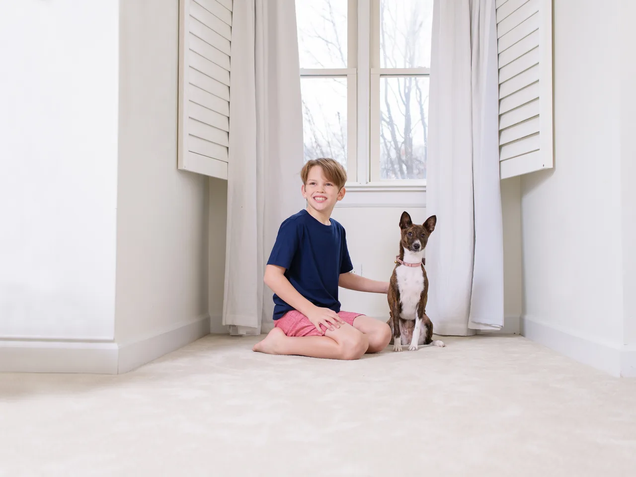 A boy hugging his dog on a freshly cleaned, odour-free carpet